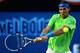 MELBOURNE, AUSTRALIA - JANUARY 26: Rafael Nadal of Spain plays a backhand in his semifinal match against Roger Federer of Switzerland during day eleven of the 2012 Australian Open at Melbourne Park on January 26, 2012 in Melbourne, Australia. (Photo by Clive Brunskill/Getty Images)