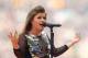SYDNEY, AUSTRALIA - OCTOBER 02: XX Kelly Clarkson performs before the 2011 NRL Grand Final match between the Manly Warringah Sea Eagles and the Warriors at ANZ Stadium on October 2, 2011 in Sydney, Australia. (Photo by Mark Metcalfe/Getty Images)