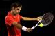 MELBOURNE, AUSTRALIA - JANUARY 26: Roger Federer of Switzerland plays a backhand in his semifinal match against Rafael Nadal of Spain during day eleven of the 2012 Australian Open at Melbourne Park on January 26, 2012 in Melbourne, Australia. (Photo by Quinn Rooney/Getty Images)