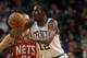 BOSTON, MA - JANUARY 04: JaJuan Johnson #12 of the Boston Celtics passes the ball as Dennis Horner #31 of the New Jersey Nets defends on January 4, 2012 at TD Garden in Boston, Massachusetts. The Boston Celtics defeated the New Jersey Nets 89-70. NOTE TO USER: User expressly acknowledges and agrees that, by downloading and or using this photograph, User is consenting to the terms and conditions of the Getty Images License Agreement. (Photo by Elsa/Getty Images)
