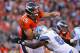 DENVER, CO - OCTOBER 30: Quarterback Tim Tebow #15 of the Denver Broncos is hit by Cliff Avril #92 of the Detroit Lions as he delivers a pass Sports Authority at Invesco Field at Mile High on October 30, 2011 in Denver, Colorado. The Lions defeated the Broncos 45-10. (Photo by Doug Pensinger/Getty Images)