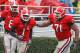 ATHENS, GA - NOVEMBER 29: Wide receiver A.J. Green #8 (L) and offensive lineman Cordy Glenn #71 (R) of the Georgia Bulldogs congratulate Mohamed Massaquoi #1 after one of his three first half touchdowns during the game against the Georgia Tech Yellow Jackets at Sanford Stadium on November 29, 2008 in Athens, Georgia. The Yellow Jackets beat the Bulldogs 45-42. (Photo by Mike Zarrilli/Getty Images)