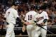 MINNEAPOLIS, MN - SEPTEMBER 7: Luke Hughes #38 of the Minnesota Twins congratulates Joe Mauer #7 and Danny Valencia #19 on scoring against the Chicago White Sox in the third inning on September 7, 2011 at Target Field in Minneapolis, Minnesota. (Photo by Hannah Foslien/Getty Images)
