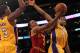 LOS ANGELES, CA - JANUARY 13: Ramon Sessions #3 of the Cleveland Cavaliers goes up for a shot between Darius Morris #1 and Devin Ebanks #3 of the Los Angeles Lakers at Staples Center on January 13, 2012 in Los Angeles, California. The Lakers won 97-92. NOTE TO USER: User expressly acknowledges and agrees that, by downloading and or using this photograph, User is consenting to the terms and conditions of the Getty Images License Agreement. (Photo by Stephen Dunn/Getty Images)