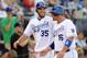 KANSAS CITY, MO - JULY 23: Eric Hosmer #35 and Billy Butler #16 of the Kansas City Royals laugh after a double off the batt of Mike Moustakas scored both during the 4th inning of the game against the Tampa Bay Rays on July 23, 2011 at Kauffman Stadium in Kansas City, Missouri. (Photo by Jamie Squire/Getty Images)