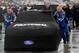 DAYTONA BEACH, FL - FEBRUARY 26: Crew members move the #99 Fastenal Ford down pit lane to facilitate track drying during a rain delay at the NASCAR Sprint Cup Series Daytona 500 at Daytona International Speedway on February 26, 2012 in Daytona Beach, Florida. (Photo by Todd Warshaw/Getty Images for NASCAR)