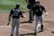 MINNEAPOLIS, MN - AUGUST 7: Carlos Quentin #20 of the Chicago White Sox congratulates Paul Konerko #14 of the Chicago White Sox on a solo home run against the Minnesota Twins in the fourth inning on August 7, 2011 at Target Field in Minneapolis, Minnesota. (Photo by Hannah Foslien/Getty Images)