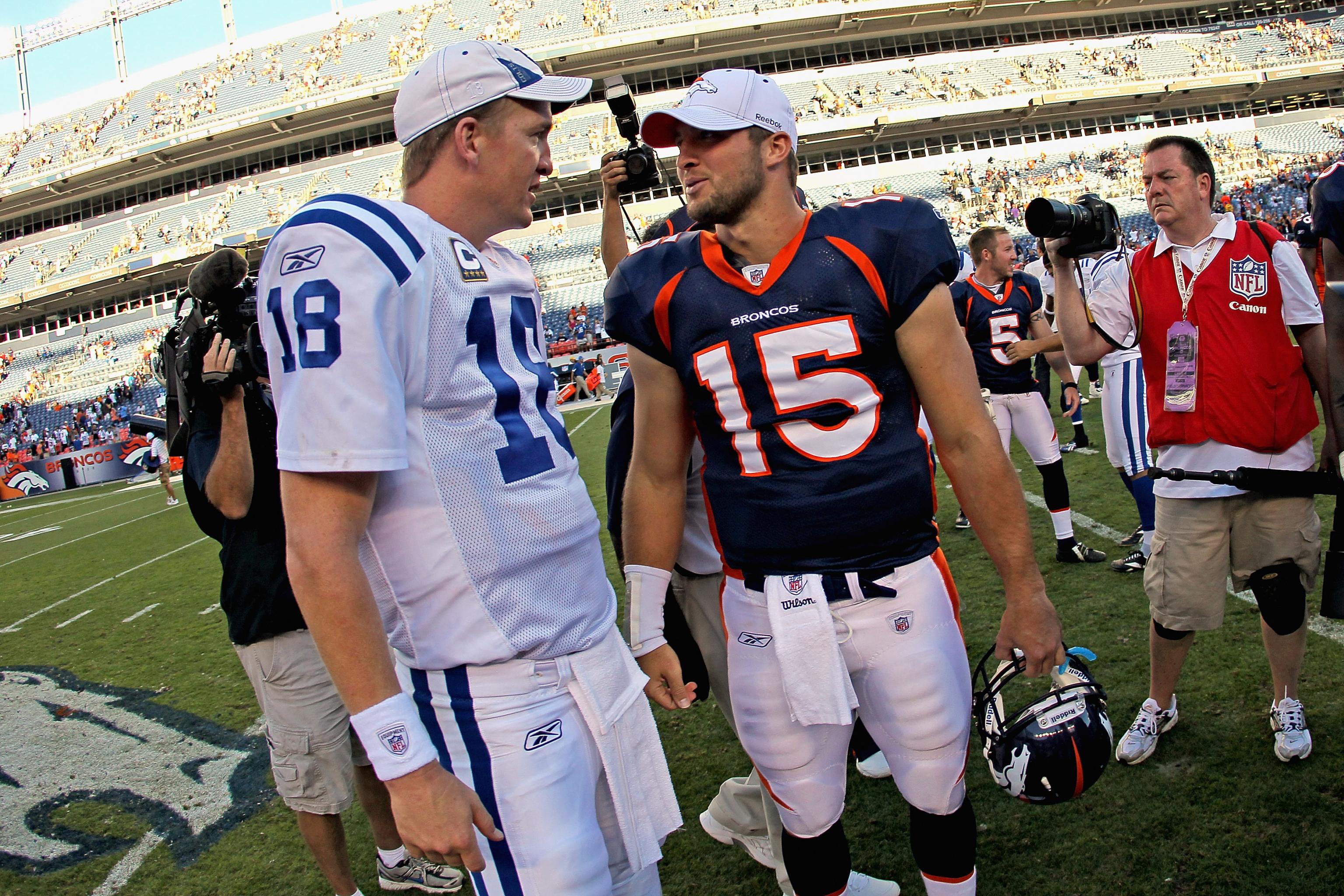 Denver Broncos quarterback Peyton Manning (18) sits on the bench