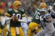 GREEN BAY, WI - JANUARY 01: Matt Flynn #10 of the Green Bay Packerslooks for a receiver as Ndamukong Suh #90 of the Detroit Lions rushes at Lambeau Field on January 1, 2012 in Green Bay, Wisconsin. The Packers defeated the Lions 45-41. (Photo by Jonathan Daniel/Getty Images)