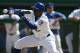 MESA, AZ - MARCH 2: Juan Pierre #9 of the Chicago Cubs lays down a bunt during a spring training game against the Oakland A's on March 2, 2006 at Hohokam Stadium in Mesa, Arizona. The Cubs defeated the A's 8-7. (Photo by Jeff Gross/Getty Images)