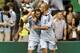 Graham Zusi (l) and Aurelien Collin celebrate v. New England