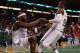 BOSTON, MA - JANUARY 04: Jermaine O'Neal #7 of the Boston Celtics is helped up by Rajon Rondo #9 after O'Neal was pushed out of bounds by Mehmet Okur #13 of the New Jersey Nets on January 4, 2012 at TD Garden in Boston, Massachusetts. NOTE TO USER: User expressly acknowledges and agrees that, by downloading and or using this photograph, User is consenting to the terms and conditions of the Getty Images License Agreement. (Photo by Elsa/Getty Images)