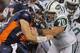 DENVER, CO - NOVEMBER 17: Quarterback Tim Tebow #15 of the Denver Broncos rushes against Mike DeVito #70 of the New York Jets at Sports Authority Field at Mile High on November 17, 2011 in Denver, Colorado. The Broncos defeated the Jets 17-13. (Photo by Doug Pensinger/Getty Images)