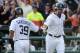 DETROIT, MI - OCTOBER 13: Alex Avila #13 of the Detroit Tigers celebrates with Ramon Santiago #39 after hitting a solo home run in the third inning of Game Five of the American League Championship Series against the Texas Rangers at Comerica Park on October 13, 2011 in Detroit, Michigan. (Photo by Harry How/Getty Images)