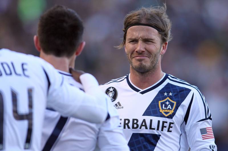 CARSON, CA - MARCH 18: David Beckham #23 of the Los Angeles Galaxy makes a face at teammate Robbie Keane #7 after Keane scored his second goal of the match against D.C. United in the second half during the MLS match at The Home Depot Center on March 18, 2012 in Carson, California. The Galaxy defeated United 3-1. (Photo by Victor Decolongon/Getty Images)