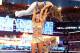 Photo: wwe.com (Maria Menounos with two cracked ribs being powerlifted)