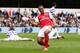 LONDON, ENGLAND - MARCH 31: Theo Walcott of Arsenal celebrates scoring his side's equalising goal during the Barclays Premier League match between Queens Park Rangers and Arsenal at Loftus Road on March 31, 2012 in London, England. (Photo by Ian Walton/Getty Images)