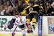 BOSTON, MA - MARCH 29: Milan Lucic #17 of the Boston Bruins is hit by Cody Eakin #50 of the Washington Capitals on March 29, 2012 at TD Garden in Boston, Massachusetts. (Photo by Elsa/Getty Images)
