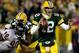 GREEN BAY, WI - DECEMBER 25: Quarterback Aaron Rodgers #12 of the Green Bay Packers is chased out of the pocket while playing the Chicago Bears at Lambeau Field on December 25, 2011 in Green Bay, Wisconsin. (Photo by Matthew Stockman/Getty Images)