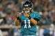 JACKSONVILLE, FL - DECEMBER 5: Quarterback Blaine Gabbert #11 of the Jacksonville Jaguars salutes a touchdown run by running back Maurice Jones-Drew #32 against the San Diego Chargers in a Monday Night Football game December 5, 2011 at EverBank Field in Jacksonville, Florida. (Photo by Al Messerschmidt/Getty Images)