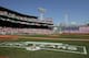 BOSTON, MA - APRIL 16: The flag covers the Green Monster as the national anthem is played before the game between the Boston Red Sox and the Tampa Bay Rays on April 16, 2012 at Fenway Park in Boston, Massachusetts. (Photo by Elsa/Getty Images)