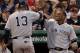 BOSTON, MA - APRIL 21: Robinson Cano #24 of the New York Yankees congratulates Alex Rodriguez #13 after Rodriguez scored in the eighth inning against the Boston Red Sox on April 21, 2012 at Fenway Park in Boston, Massachusetts. (Photo by Elsa/Getty Images)