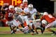 LINCOLN, NE - OCTOBER 8: Quarterback Braxton Miller #5 of the Ohio State Buckeyes slips between safety Austin Cassidy #8 of the Nebraska Cornhuskers and linebacker Will Compton #51 of the Nebraska Cornhuskers during their game at Memorial Stadium October 8, 2011 in Lincoln, Nebraska. Nebraska Defeated Ohio State 34-27. (Photo by Eric Francis/Getty Images)