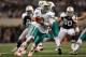 ARLINGTON, TX - NOVEMBER 24: Matt Moore #8 of the Miami Dolphins looks to hand off the ball against the Dallas Cowboys during the Thanksgiving Day game at Cowboys Stadium on November 24, 2011 in Arlington, Texas. (Photo by Ronald Martinez/Getty Images)
