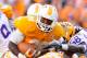 KNOXVILLE, TN - OCTOBER 15: Tauren Poole #28 of the Tennessee Volunteers tries to break a tackle by Tahj Jones #58 of the LSU Tigers at Neyland Stadium on October 15, 2011 in Knoxville, Tennessee. (Photo by Kevin C. Cox/Getty Images)