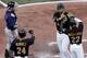 Pedro Alvarez and Andrew McCutchen greet Garrett Jones after his two-run home run.