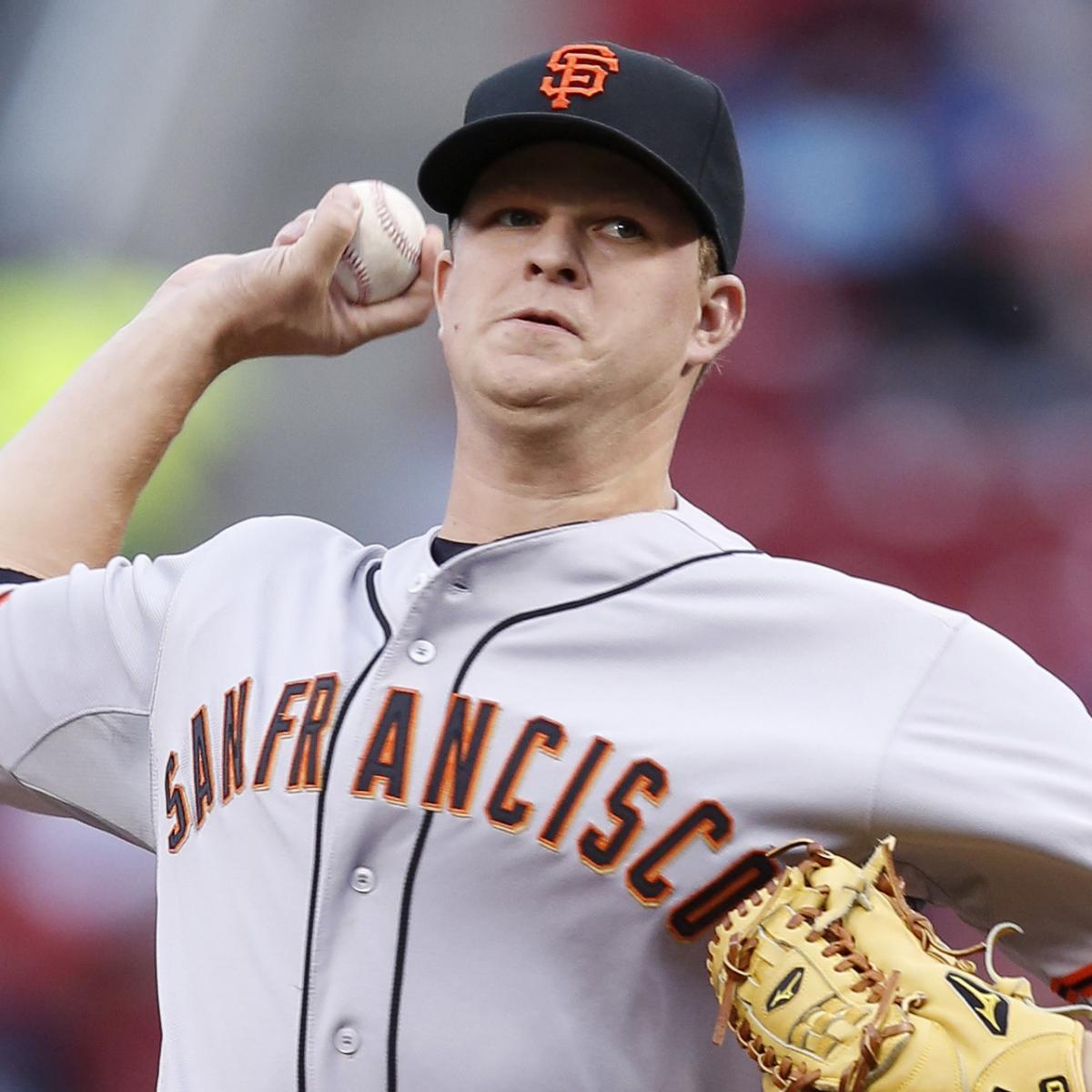 Matt Cain of the San Francisco Giants gives a thumbs up to a teammate after  the…