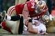 SAN FRANCISCO, CA - JANUARY 14: Justin Smith #94 of the San Francisco 49ers hovers over Drew Brees #9 of the New Orleans Saints after Brees was sacked in the third quarter of the NFC Divisional playoff game at Candlestick Park on January 14, 2012 in San Francisco, California. (Photo by Jed Jacobsohn/Getty Images)