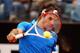 ROME, ITALY - MAY 16: Roger Federer of Switzerland plays a backhand against Carlos Berlocq of Argentina in their second round match during day five of the Internazionali BNL d'Italia 2012 at the Foro Italico Tennis Centre on May 16, 2012 in Rome, Italy. (Photo by Clive Brunskill/Getty Images)