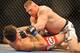 LAS VEGAS - JULY 11: Brock Lesnar holds down Frank Mir during their heavyweight title bout during UFC 100 on July 11, 2009 in Las Vegas, Nevada. Lesnar defeated Mir by a second round knockout. (Photo by Jon Kopaloff/Getty Images)