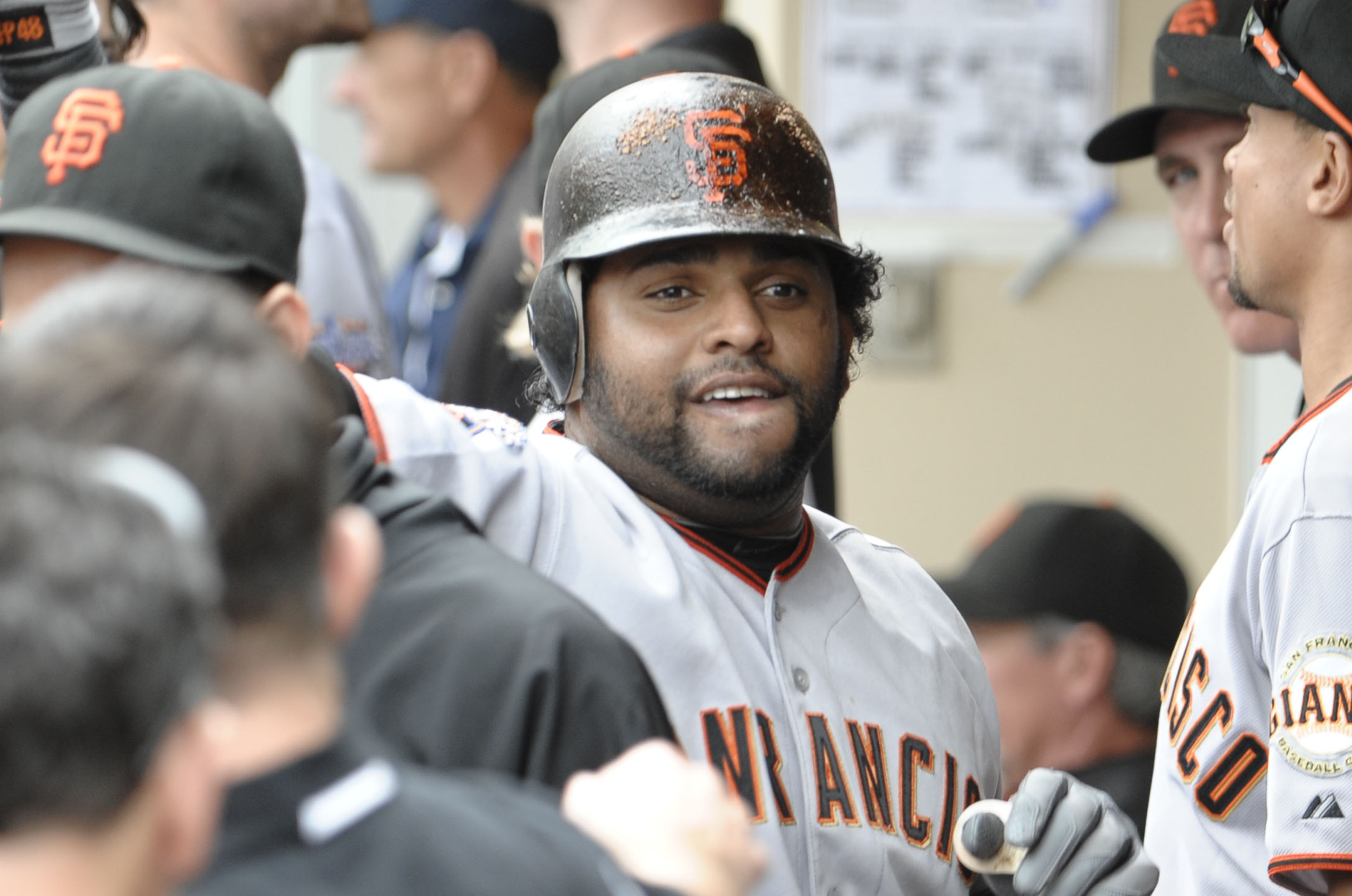 Pablo Sandoval removes his jersey as he enters the clubhouse after