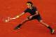 PARIS, FRANCE - JUNE 01: Roger Federer of Switzerland slides to play a forehand during his men's singles third round match against Nicolas Mahut of France during day six of the French Open at Roland Garros on June 1, 2012 in Paris, France. (Photo by Mike Hewitt/Getty Images)
