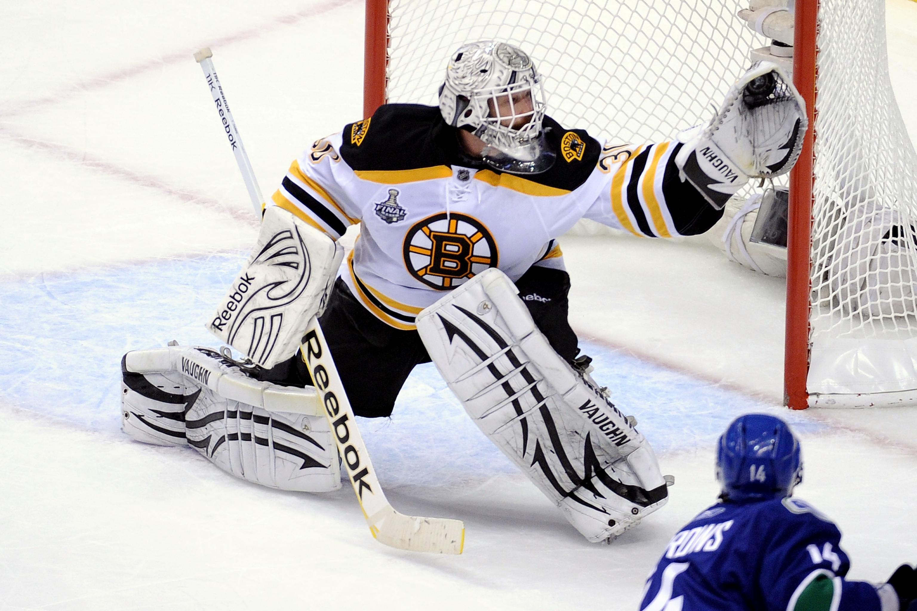 Boston Bruins goalie Tim Thomas makes a diving save as