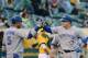 Yunel Escobar and Kelly Johnson high-five after a Johnson home run.