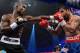 LAS VEGAS, NV - JUNE 09: (L-R) Timothy Bradley lands a left to the head of Manny Pacquiao during their WBO welterweight title fight at MGM Grand Garden Arena on June 9, 2012 in Las Vegas, Nevada. (Photo by Kevork Djansezian/Getty Images)