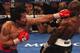 LAS VEGAS, NV - JUNE 09: (L-R) Manny Pacquiao lands a left to the head of Timothy Bradley during their WBO welterweight title fight at MGM Grand Garden Arena on June 9, 2012 in Las Vegas, Nevada. (Photo by Jeff Bottari/Getty Images)