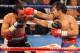 LAS VEGAS, NV - NOVEMBER 12: Manny Pacquiao (R) throws a right at Juan Manuel Marquez during the ninth round of their WBO world welterweight title fight at the MGM Grand Garden Arena November 12, 2011 in Las Vegas, Nevada. Pacquiao retained his title with a majority decision victory. (Photo by Ethan Miller/Getty Images)