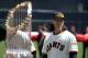 Tim Lincecum poses with the 2010 World Series trophy before San Francisco's win over St. Louis on April 8, 2011.