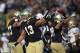 SOUTH BEND, IN - OCTOBER 29: Danny Spond #13 of the Notre Dame Fighting Irish joins teammates in celebrating a turn-over against the Navy Midshipmen at Notre Dame Stadium on October 29, 2011 in South Bend, Indiana. Notre Dame defeated Navy 56-14. (Photo by Jonathan Daniel/Getty Images)
