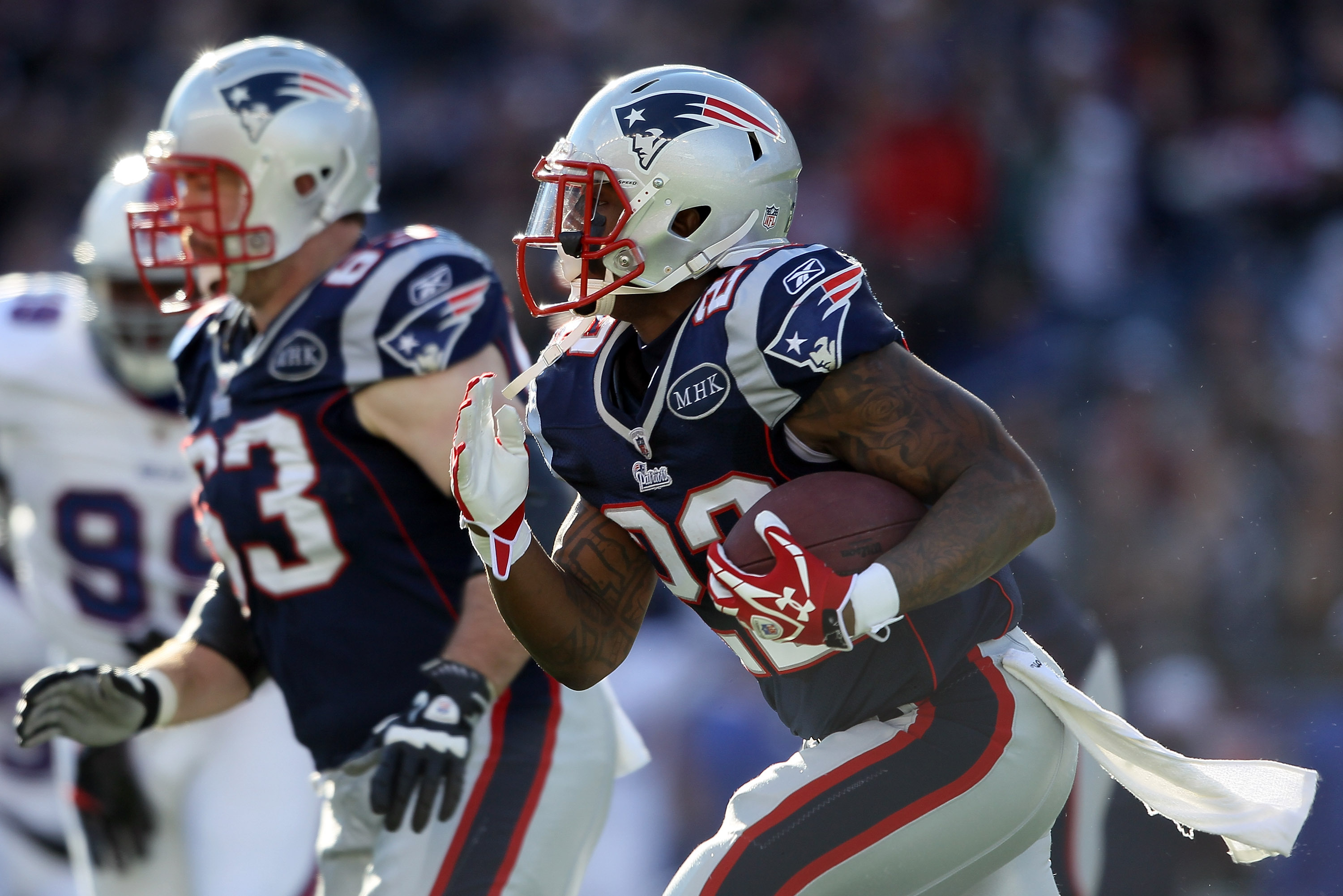 New England Patriots fullback James Develin, front, gets help with