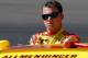 AVONDALE, AZ - MARCH 03: A.J. Allmendinger, driver of the #22 Shell Pennzoil Dodge, looks on from the grid during qualifying for the NASCAR Sprint Cup Series SUBWAY Fresh Fit 500 at Phoenix International Raceway on March 3, 2012 in Avondale, Arizona. (Photo by Tyler Barrick/Getty Images for NASCAR)