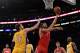 LOS ANGELES, CA - APRIL 06: Luis Scola #4 of the Houston Rockets scores on a layup past Paul Gasol #16 of the Los Angeles Lakers during a 112-107 Rocets win at Staples Center on April 6, 2012 in Los Angeles, California. NOTE TO USER: User expressly acknowledges and agrees that, by downloading and or using this photograph, User is consenting to the terms and conditions of the Getty Images License Agreement. (Photo by Harry How/Getty Images)