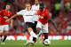 MANCHESTER, ENGLAND - AUGUST 22: Michael Dawson of Tottenham Hotspur tackles Danny Welbeck of Manchester United during the Barclays Premier League match between Manchester United and Tottenham Hotspur at Old Trafford on August 22, 2011 in Manchester, England. (Photo by Alex Livesey/Getty Images)