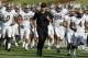 LOS ANGELES - OCTOBER 2: Head coach Steve Sarkisian of the Washington Huskies runs off the field with his team after warmups for th game with the USC Trojans at the Los Angeles Memorial Coliseum on October 2, 2010 in Los Angeles, California. (Photo by Stephen Dunn/Getty Images)
