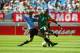 SUWON - JUNE 11: Henri Camara of Senegal (right) is tackled by Alejandro Lembo of Uruguay during the first half during the Uruguay v Senegal Group A, World Cup Group Stage match played at the Suwon World Cup Stadium, Suwon, South Korea on June 11, 2002. The game was drawn 3 - 3. (Photo by Ben Radford/Getty Images)