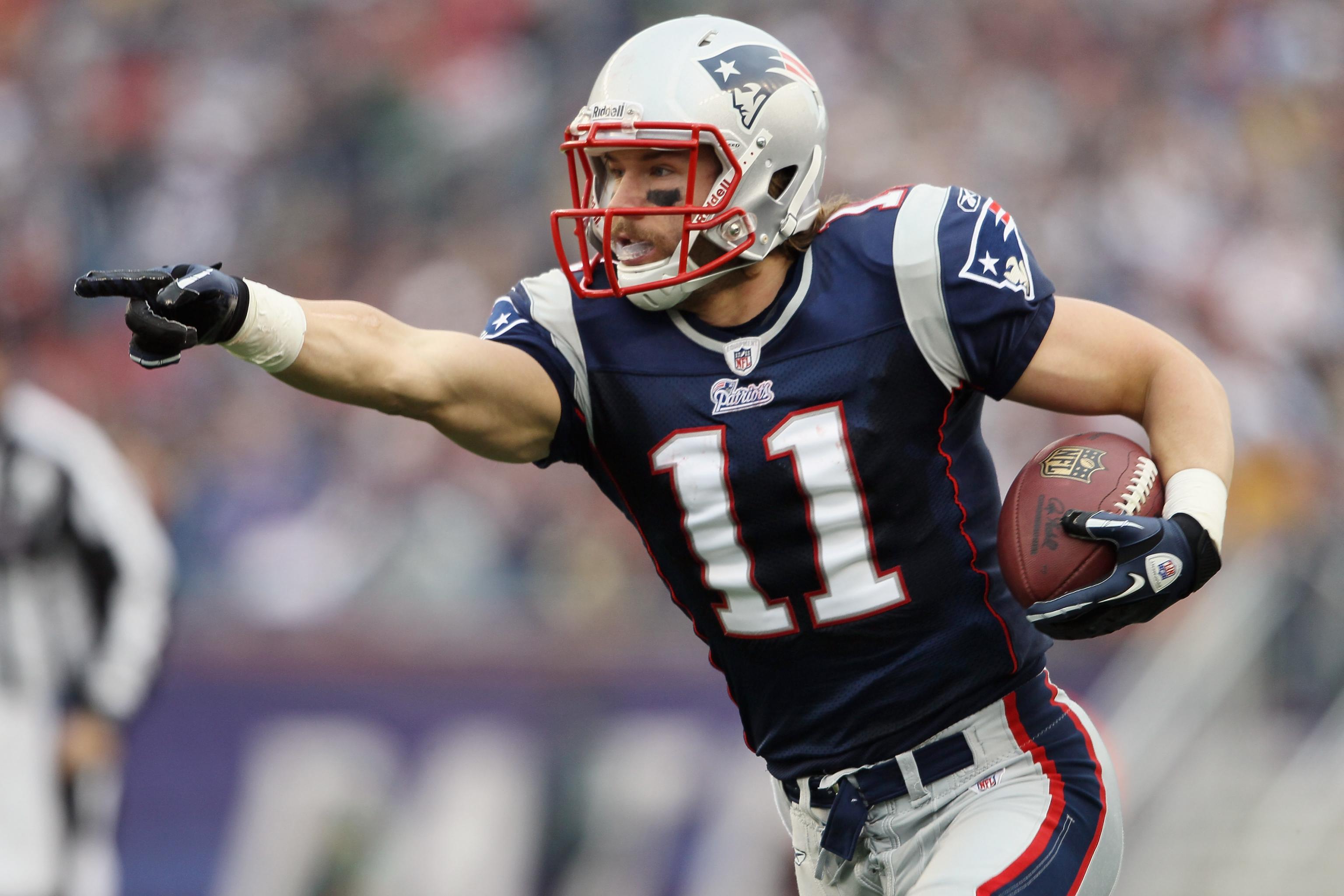 New England Patriots wide receiver Julian Edelman (11) carries back a punt  return for a 30 yard gain in the first quarter against the New York Jets in  week 12 of the